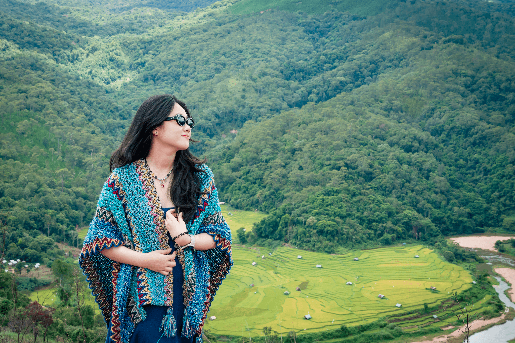 cô gái đứng tạo dáng chụp ảnh trong photo tour măng đen tại kon tu rằng với khung cảnh phía sau là ruộng bậc thang uốn lượn quanh rừng núi có suối, thác